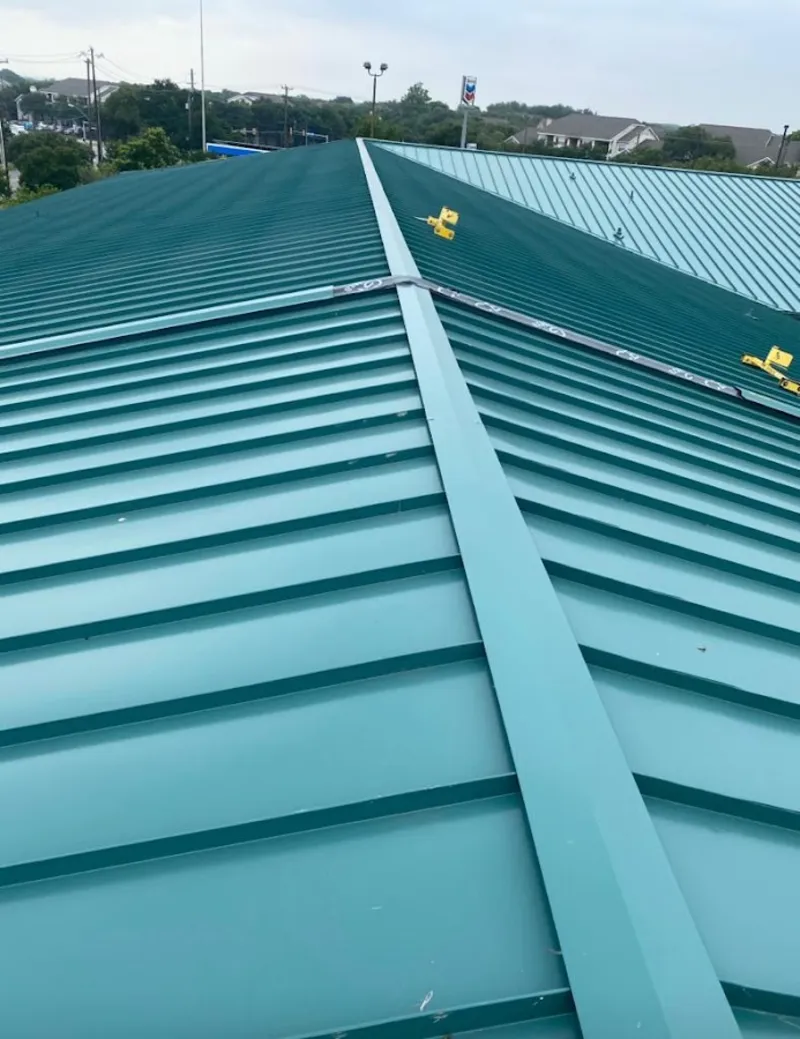 Green commercial metal roof ridge and valley for Metal Roof Repair in Lowell